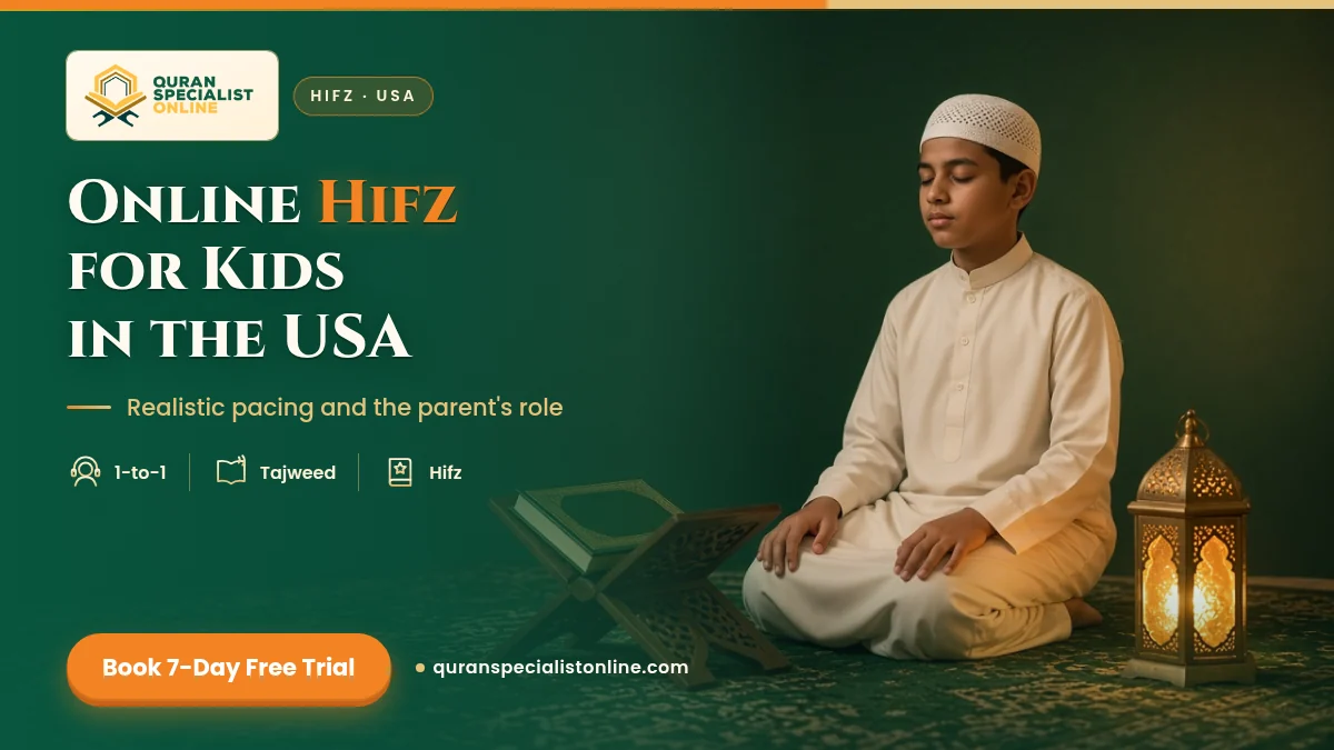 A boy in a white thobe and kufi sits on a prayer rug with eyes closed, reciting from memory beside a closed Quran on a wooden stand.