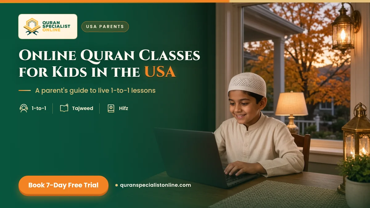 A boy in a white kufi smiles at a laptop during an online Quran class in an American home, with autumn trees outside the window.