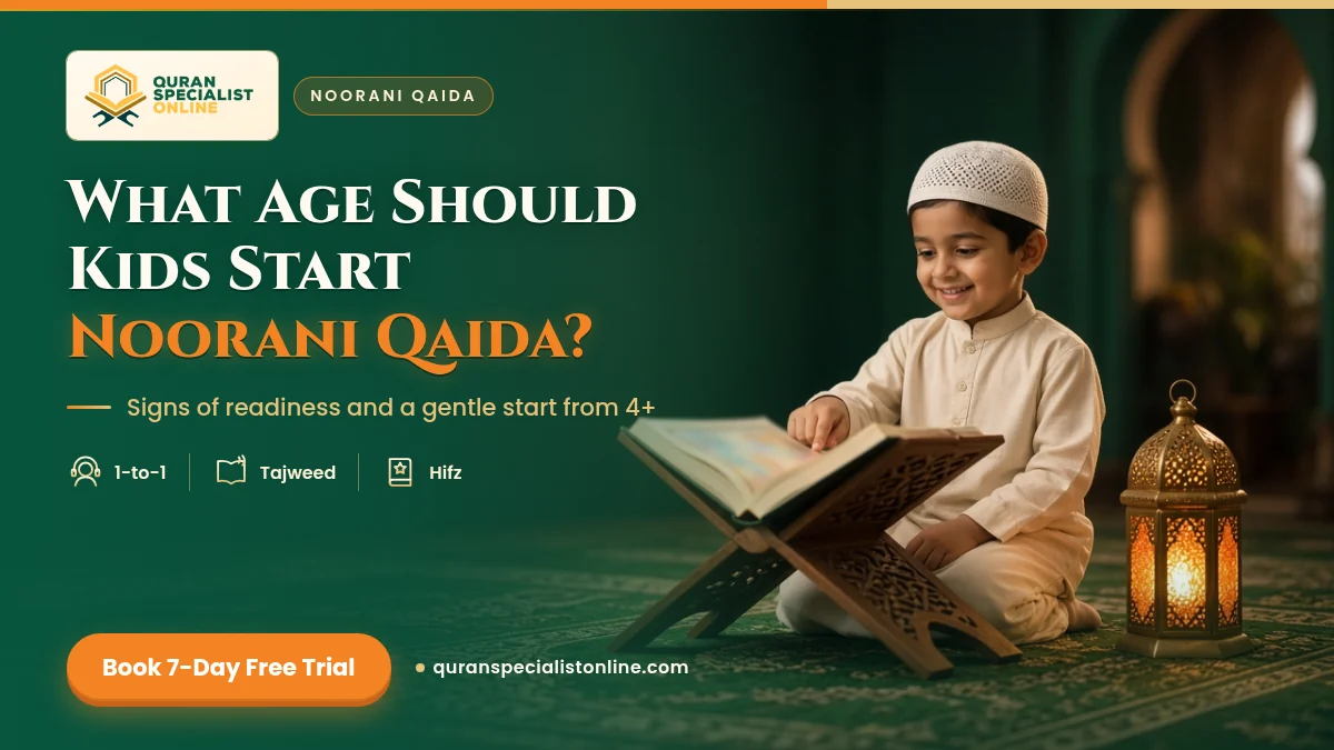 A smiling young boy in a white kufi points at a beginner's book on a wooden stand, with a lantern glowing beside him.